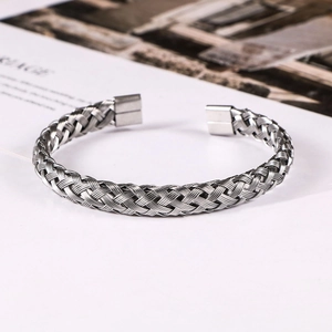 Macro detail of silver twisted wire cable bracelet showing woven texture and polished ends
