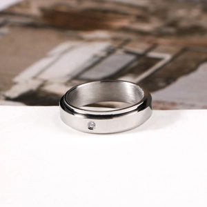 Minimalist stainless steel spinner ring for couples with brushed finish and small zircon