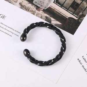 Macro view of black twisted rope textured cuff bracelet with polished spherical ends
