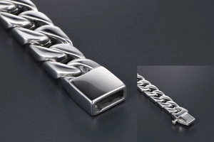 Detail of silver titanium steel Cuban link bracelet with secure push-button clasp