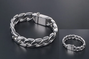 Detailed macro view of a polished stainless steel Cuban link bracelet with a secure box clasp