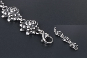 Detail of vintage rose link bracelet in stainless steel with large lobster clasp