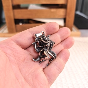 Close-up of vintage silver fox deity pendant showing detailed stainless steel craftsmanship