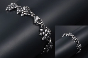 Detail of vintage oxidized stainless steel bracelet with 3D rose flower links and clasp