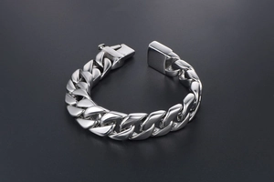 Close-up of polished titanium steel Cuban link bracelet with a secure box clasp