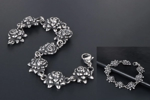 Detailed close-up of antique silver steel bracelet featuring carved rose floral links