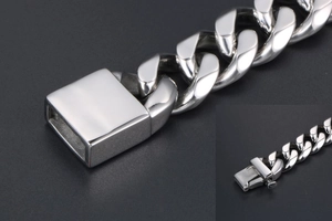 Detailed macro view of the box clasp and thick silver steel links on the hip-hop bracelet