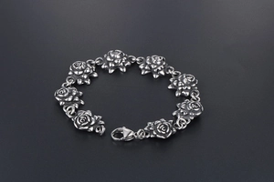 Detailed macro view of vintage rose link stainless steel bracelet with oxidized finish