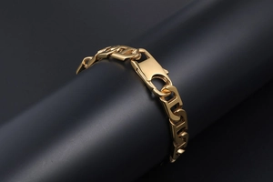 Detailed close-up of gold-plated H-link bracelet with a sturdy lobster clasp on display