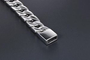 Macro shot of polished stainless steel cuban chain with detailed rectangular box clasp