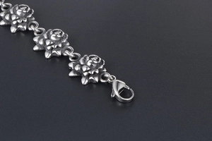 Macro detail of vintage silver rose link bracelet in stainless steel with lobster clasp