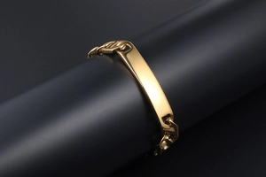 Detailed close-up of polished gold-plated stainless steel curb chain with an ID bar