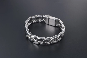 Detailed close-up of a silver stainless steel cuban chain with a secure box clasp