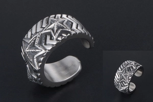 Detailed macro view showing the vintage pentagram engraving on wide stainless steel ring