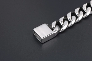 Detailed macro view of high-polish Cuban link chain with secure rectangular clasp