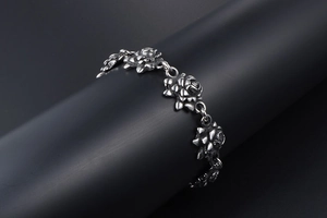 Detailed macro view of vintage rose shaped titanium steel bracelet with oxidized finish