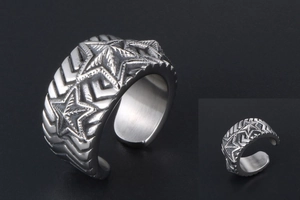 Detailed view of retro stainless steel star ring with embossed patterns and oxidized finish