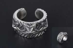 Macro view of vintage stainless steel wide star ring with textured industrial details