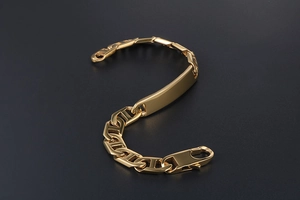 Close-up of gold-plated H-link chain bracelet with a smooth rectangular ID plate