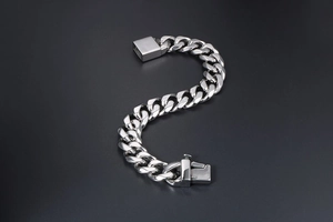 Polished silver cuban chain bracelet for men featuring a secure box clasp mechanism