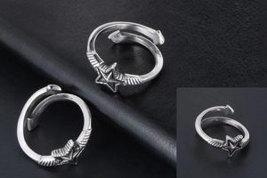 Macro view showing vintage silver star ring with detailed feather texture and antique finish