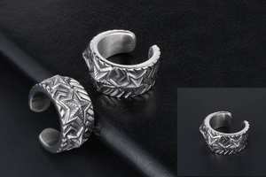 Macro detail of retro stainless steel ring with engraved star and arrow patterns