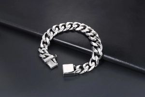 Close-up of thick silver titanium steel Cuban link bracelet with a secure square clasp