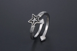 Detailed view of vintage star open ring with radial texture and arrowhead bypass band