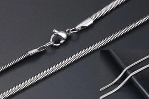 Detailed close-up of a polished silver snake chain necklace featuring a secure lobster clasp