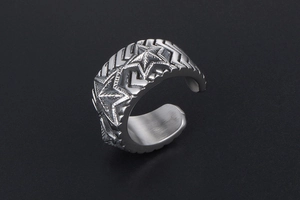 Macro detail of vintage stainless steel wide ring with engraved pentagram and textured edges