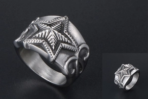 Macro shot of industrial vintage stainless steel ring with relief star and line texture