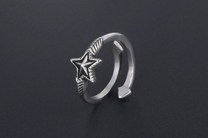 Macro shot of silver vintage star ring with arrow ends and distressed finish