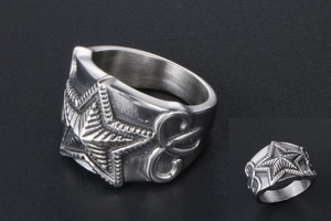 Detail view of retro men's star ring featuring vintage floral pattern and matte steel finish