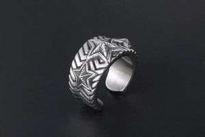 Detailed view of retro stainless steel ring with five-pointed star and chevron patterns