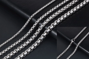 Detail of titanium steel box chains in multiple thicknesses with lobster clasp close-up