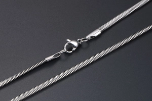 Macro detail of silver snake chain texture and secure lobster clasp closure