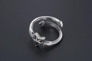 Macro shot of vintage star open ring with wing details and an antique silver finish