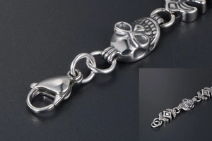 Close-up of gothic skull chain links and lobster clasp on punk titanium steel bracelet