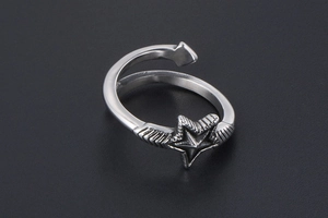 Macro detail of vintage silver open star ring with textured wing design and adjustable band