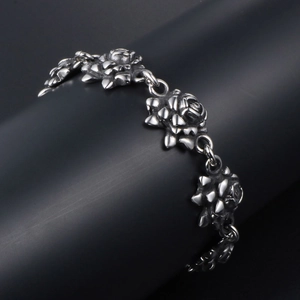 Vintage stainless steel rose bracelet with distressed silver finish on display