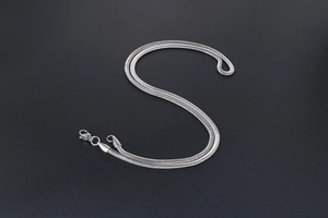 Detailed view of silver snake bone chain necklace with secure lobster clasp closure