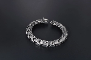 Macro shot of punk style dragon scale steel bracelet with antique silver texture
