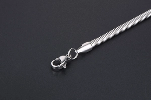 Detailed macro view of silver snake chain texture with classic lobster clasp closure