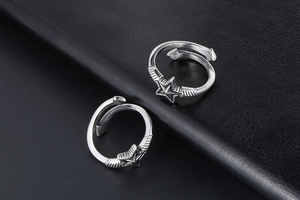 Macro detail of retro punk adjustable open rings with 3D star motif and silver texture