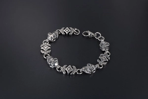 Detail of gothic skull link bracelet in titanium steel with lobster clasp and intricate carving