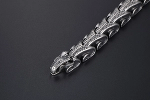 Macro shot of punk style dragon scale pattern links on a vintage steel bracelet