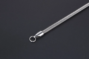 Macro detail of silver snake bone chain showing sleek metallic texture and links