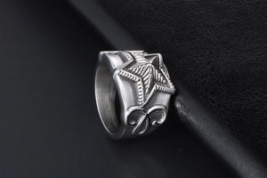 Macro shot of vintage silver star ring featuring detailed side scrollwork engravings