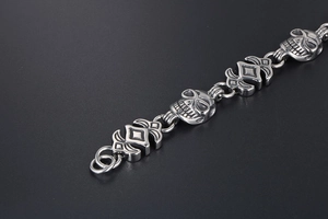 Close-up of punk style titanium steel skull bracelet with vintage silver finish