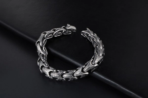 Macro detail of punk dragon scale bracelet in vintage cast stainless steel finish